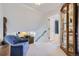 Bright upper-level hallway leading to the bathroom with a decorative cabinet on the side at 6227 Colorow Dr, Morrison, CO 80465