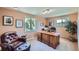 Inviting home office features a large wooden desk, comfortable leather chair, and bright natural light at 6227 Colorow Dr, Morrison, CO 80465