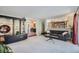 Bright living room featuring modern shelving and a view into the kitchen and dining area at 6227 Colorow Dr, Morrison, CO 80465