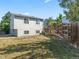 Large backyard featuring a well-maintained lawn, mature trees and partial fence at 17411 E Layton Dr, Aurora, CO 80015