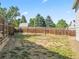 Spacious backyard with a wooden fence providing privacy and shade from mature trees at 17411 E Layton Dr, Aurora, CO 80015