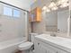 Well-lit bathroom featuring a modern vanity, mirror, and a shower-tub combination, creating a functional space at 17411 E Layton Dr, Aurora, CO 80015