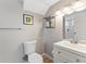 Bright bathroom features a modern sink, toilet, and mirrored vanity with modern fixtures at 17411 E Layton Dr, Aurora, CO 80015