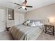 Comfortable bedroom featuring a neutral color scheme, ceiling fan, and ample closet space for organized storage at 17411 E Layton Dr, Aurora, CO 80015