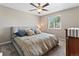 Cozy bedroom featuring a ceiling fan and a large window for natural light, creating a relaxing atmosphere at 17411 E Layton Dr, Aurora, CO 80015