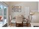 Bright dining area with a wood table, comfortable seating, and sliding glass door access to the outdoor space at 17411 E Layton Dr, Aurora, CO 80015