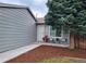 Charming home entrance with seating area and well-maintained landscaping at 17411 E Layton Dr, Aurora, CO 80015