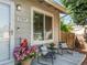 Cozy front porch with seating and charming decor welcomes visitors to this lovely home at 17411 E Layton Dr, Aurora, CO 80015