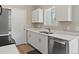 Modern kitchen featuring stainless steel appliances, white cabinets, and sleek countertops at 17411 E Layton Dr, Aurora, CO 80015