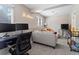 Cozy living area featuring a desk and tv, and comfortable seating arrangement for relaxation and entertainment at 17411 E Layton Dr, Aurora, CO 80015