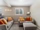 Comfortable living room featuring neutral walls, plush seating and bright natural light at 17411 E Layton Dr, Aurora, CO 80015