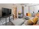 Cozy living area featuring comfortable seating, a television, and a bar cart for a relaxing entertainment at 17411 E Layton Dr, Aurora, CO 80015
