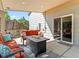 Cozy covered patio with comfortable seating, fire pit, and convenient access to the home's interior at 17411 E Layton Dr, Aurora, CO 80015