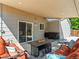Inviting covered patio features stylish furniture, a fire pit, and seamless access to the home at 17411 E Layton Dr, Aurora, CO 80015