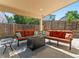 Covered patio featuring comfortable seating around a modern fire pit, perfect for outdoor relaxation at 17411 E Layton Dr, Aurora, CO 80015