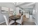 Well-lit dining room with a view of the kitchen and three neutral-colored chairs around a table at 601 S Fairplay St # A, Aurora, CO 80012