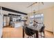 An open layout with an adjacent dining area and black marble table complements the stainless steel appliances at 9110 E Lehigh Ave, Denver, CO 80237