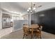 Inviting dining area with a wooden table, chandelier lighting, and a view of the adjacent kitchen at 8199 Welby Rd # 1907, Denver, CO 80229