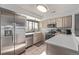 Bright kitchen featuring stainless steel appliances, light-colored cabinets, and a view of the outside at 8199 Welby Rd # 1907, Denver, CO 80229