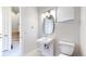 Small bathroom with modern vanity, lighting, and toilet, near the staircase at 1937 S Columbine St, Denver, CO 80210