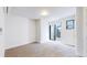 A bright, carpeted bedroom with sliding glass doors to a balcony at 1937 S Columbine St, Denver, CO 80210