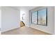Bright bedroom with large window and light wood stairs at 1937 S Columbine St, Denver, CO 80210