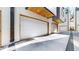 Modern two car garage doors and concrete driveway with stylish wood accents at 1937 S Columbine St, Denver, CO 80210
