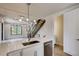 Bright, modern kitchen featuring quartz countertops, stainless steel appliances, and designer lighting at 1937 S Columbine St, Denver, CO 80210