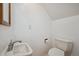 Powder room featuring a sleek white toilet, modern sink, and a crisp, clean aesthetic for guests at 6700 W 11Th Ave # 202, Lakewood, CO 80214