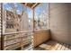 Private outdoor deck with wood plank flooring and views of trees, creek, and nature at 6700 W 11Th Ave # 202, Lakewood, CO 80214