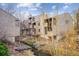 Exterior view of condo buildings and common grounds along a creek with mature landscaping at 6700 W 11Th Ave # 202, Lakewood, CO 80214
