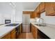 Bright kitchen featuring stainless steel appliances, modern countertops, gas range, wood cabinets, and under cabinet lighting at 6700 W 11Th Ave # 202, Lakewood, CO 80214