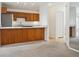 Open-concept kitchen offering wood cabinetry, a breakfast bar, modern appliances, and open to living area at 6700 W 11Th Ave # 202, Lakewood, CO 80214