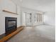 Bright living room featuring a modern fireplace with wood detail and large windows providing natural light at 6700 W 11Th Ave # 202, Lakewood, CO 80214