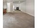Open-concept living room with fireplace, featuring carpet flooring, and a large mirror to enhance the sense of space at 6700 W 11Th Ave # 202, Lakewood, CO 80214