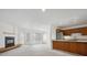 Open-concept space featuring a cozy fireplace, carpet flooring, and a convenient pass-through to the kitchen at 6700 W 11Th Ave # 202, Lakewood, CO 80214