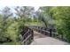 Scenic walking bridge surrounded by lush greenery and mature trees, offering a peaceful outdoor experience at 4262 E Maplewood Way, Centennial, CO 80121