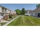 Well-maintained community grounds with lush grass, mature trees, and walking path at 4262 E Maplewood Way, Centennial, CO 80121