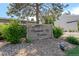 Community signage for Rembrandt Place Townhomes nestled among lush landscaping and mature trees at 4262 E Maplewood Way, Centennial, CO 80121