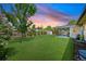 Expansive backyard featuring green lawn, wooden fence, shed, and covered patio, perfect for outdoor entertaining and relaxation at 6987 E Wyoming Pl, Denver, CO 80224