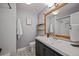 Updated bathroom with a white vanity top and modern fixtures, decorative tile floors, and subway tile in the shower at 6987 E Wyoming Pl, Denver, CO 80224