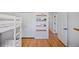 Bedroom featuring hardwood floors, white closet doors, open shelving and white doors with black hardware at 6987 E Wyoming Pl, Denver, CO 80224