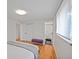 Bright bedroom with hardwood floors and access to a walk-in closet and modern bathroom at 6987 E Wyoming Pl, Denver, CO 80224