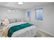 Stylish bedroom featuring modern decor, a comfortable bed, and ample natural light from two well-placed windows at 6987 E Wyoming Pl, Denver, CO 80224