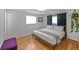 Cozy bedroom with hardwood floors and a comfortable king-size bed at 6987 E Wyoming Pl, Denver, CO 80224