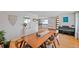 Elegant dining room with a long wooden table, modern chairs, and stylish decor accents for Gathering gatherings at 6987 E Wyoming Pl, Denver, CO 80224
