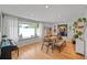 Bright dining room features a large window with seating, stylish decor, and a comfortable seating area at 6987 E Wyoming Pl, Denver, CO 80224