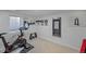 Home gym featuring a stationary bike, free weights, and a mirror at 6987 E Wyoming Pl, Denver, CO 80224