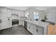 Updated kitchen with gray cabinets, stainless steel appliances, modern countertops, and an open-concept design at 6987 E Wyoming Pl, Denver, CO 80224