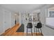 Modern kitchen with gray cabinetry, stainless steel appliances, a breakfast bar, and sleek countertops at 6987 E Wyoming Pl, Denver, CO 80224